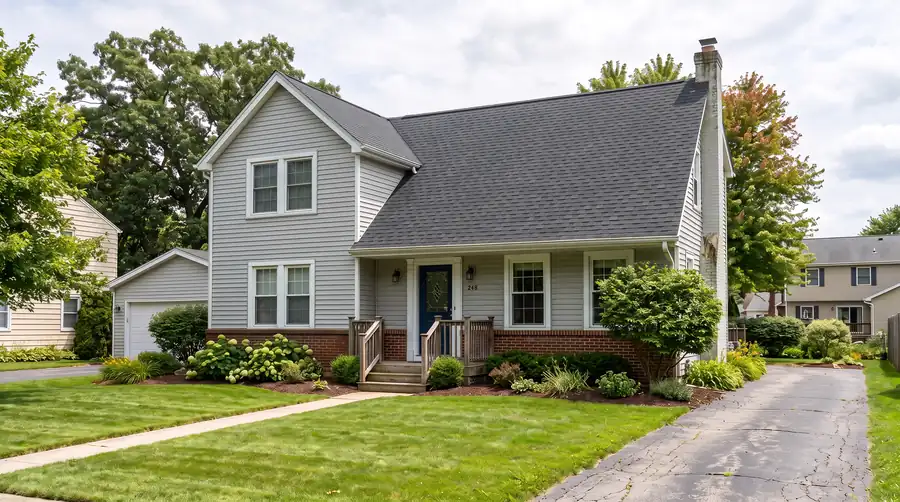 The same house after: a new charcoal shingle roof.